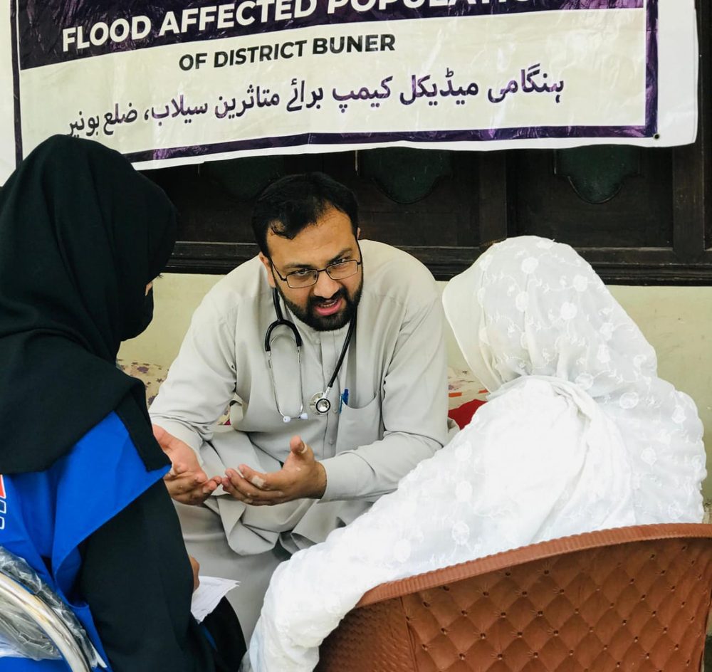 A volunteer doctor consulting with a patient during a Sehat Sitara camp