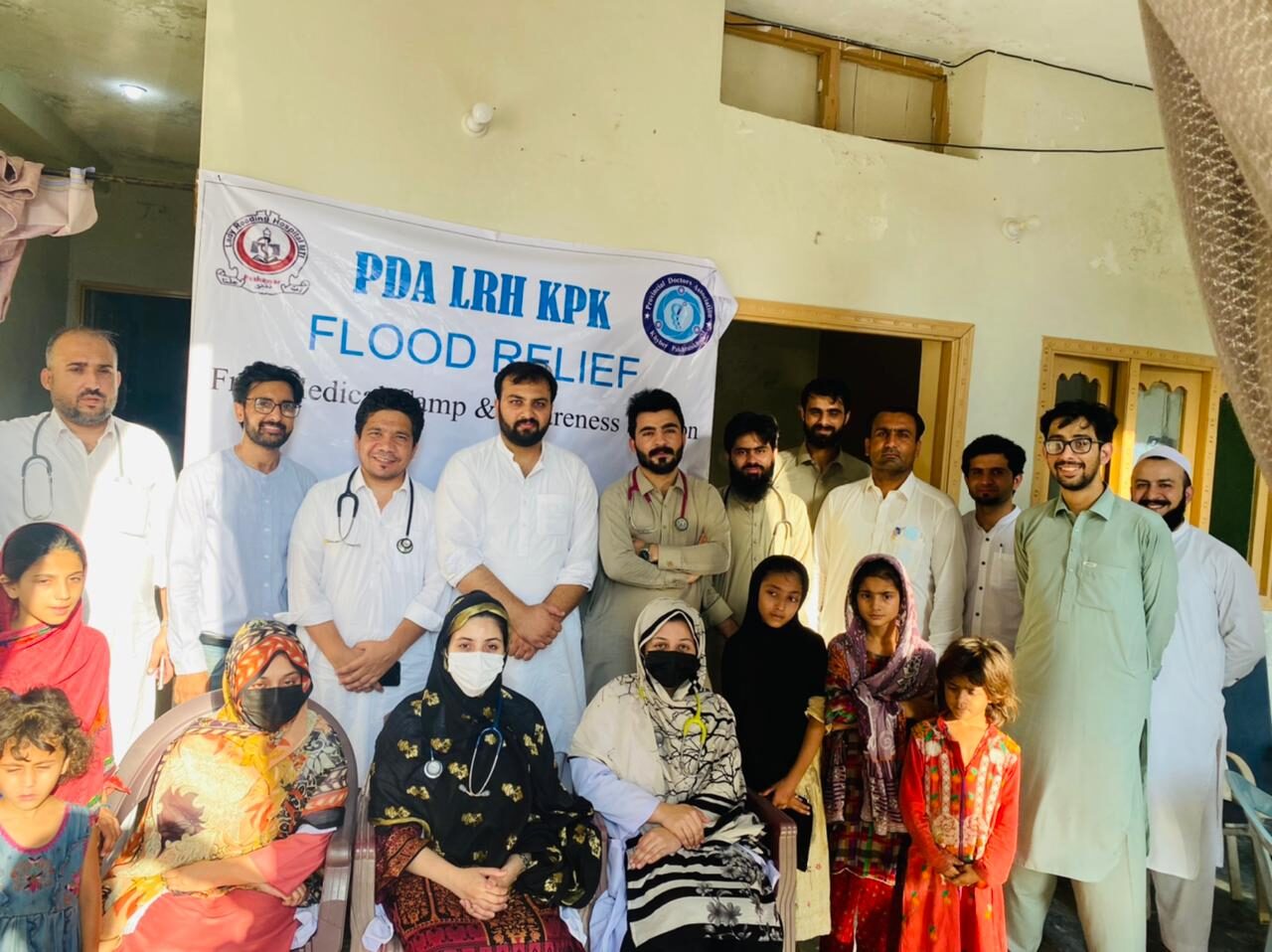 Volunteers meeting families during a community camp