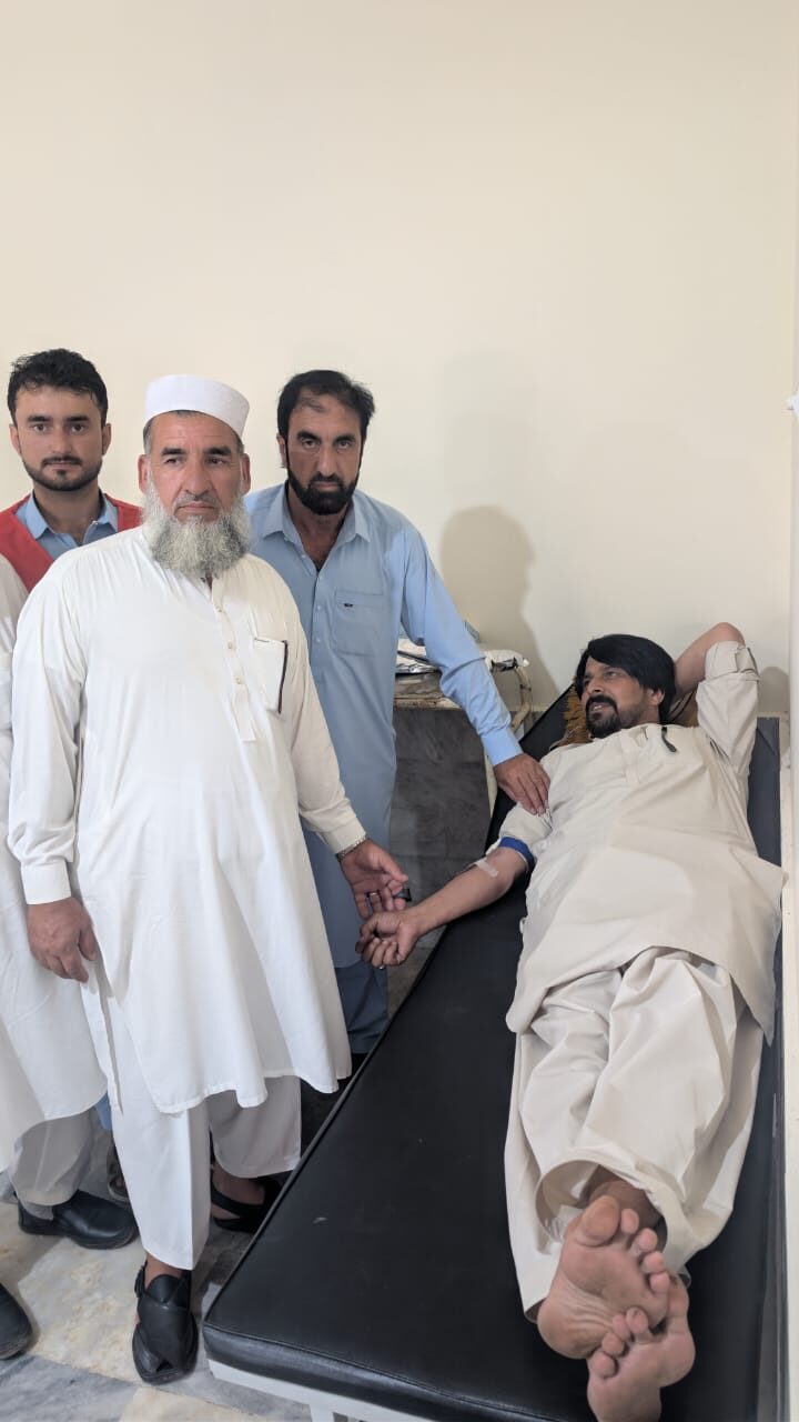 A volunteer doctor attending to a patient